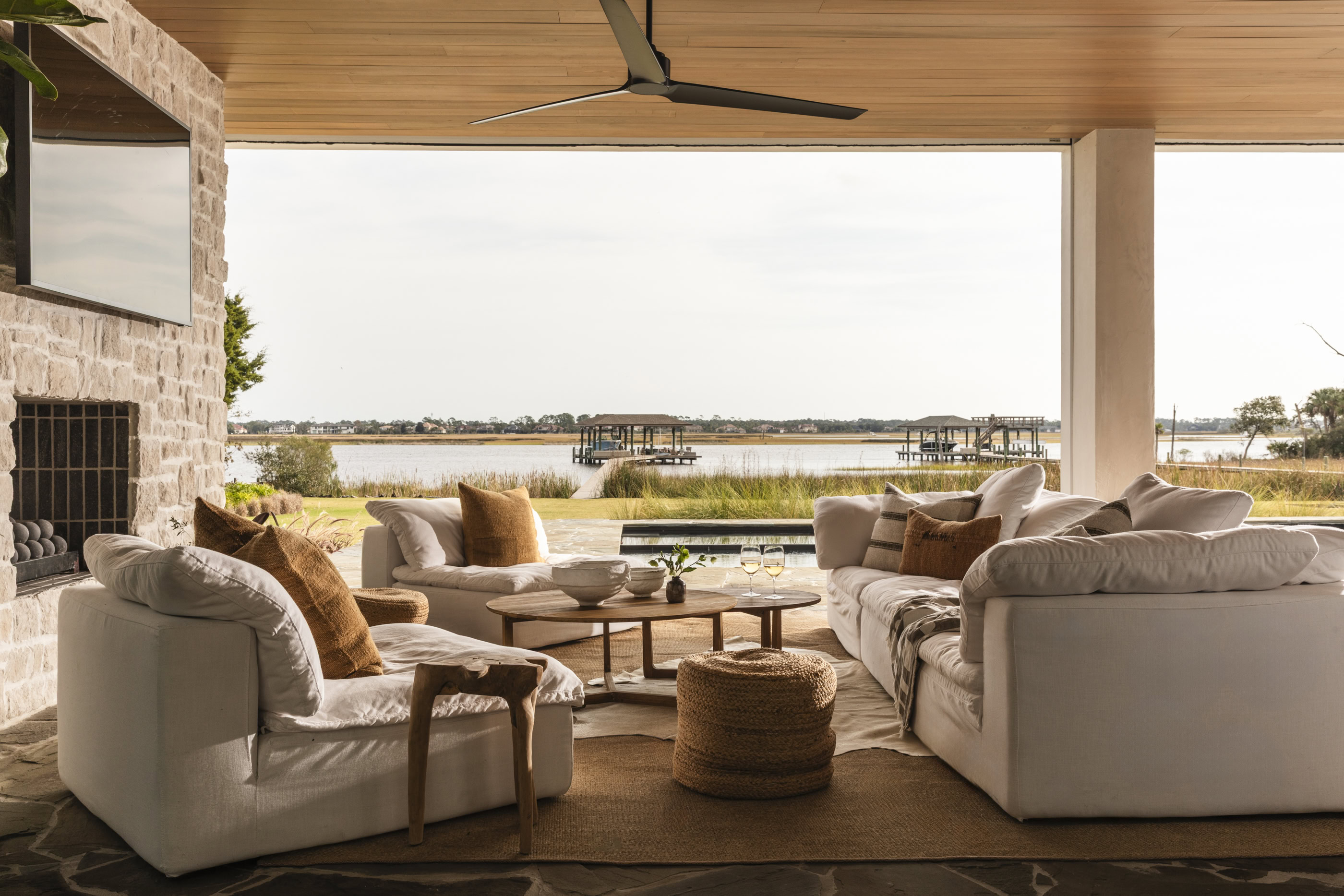 Elegant lakeside living room with comfortable sofas and scenic water views.