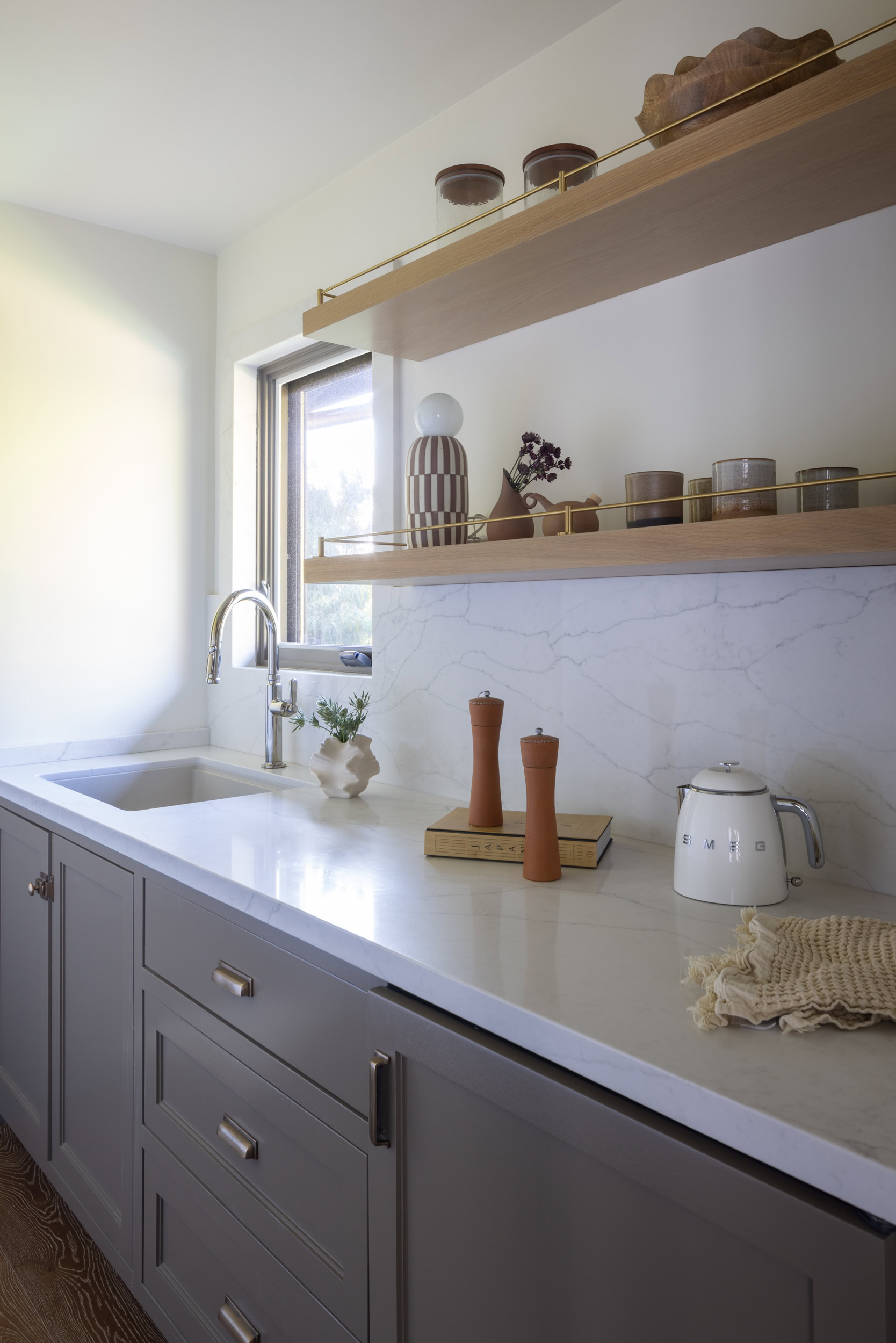 Bright kitchen featuring minimalist design and open shelving for stylish storage.