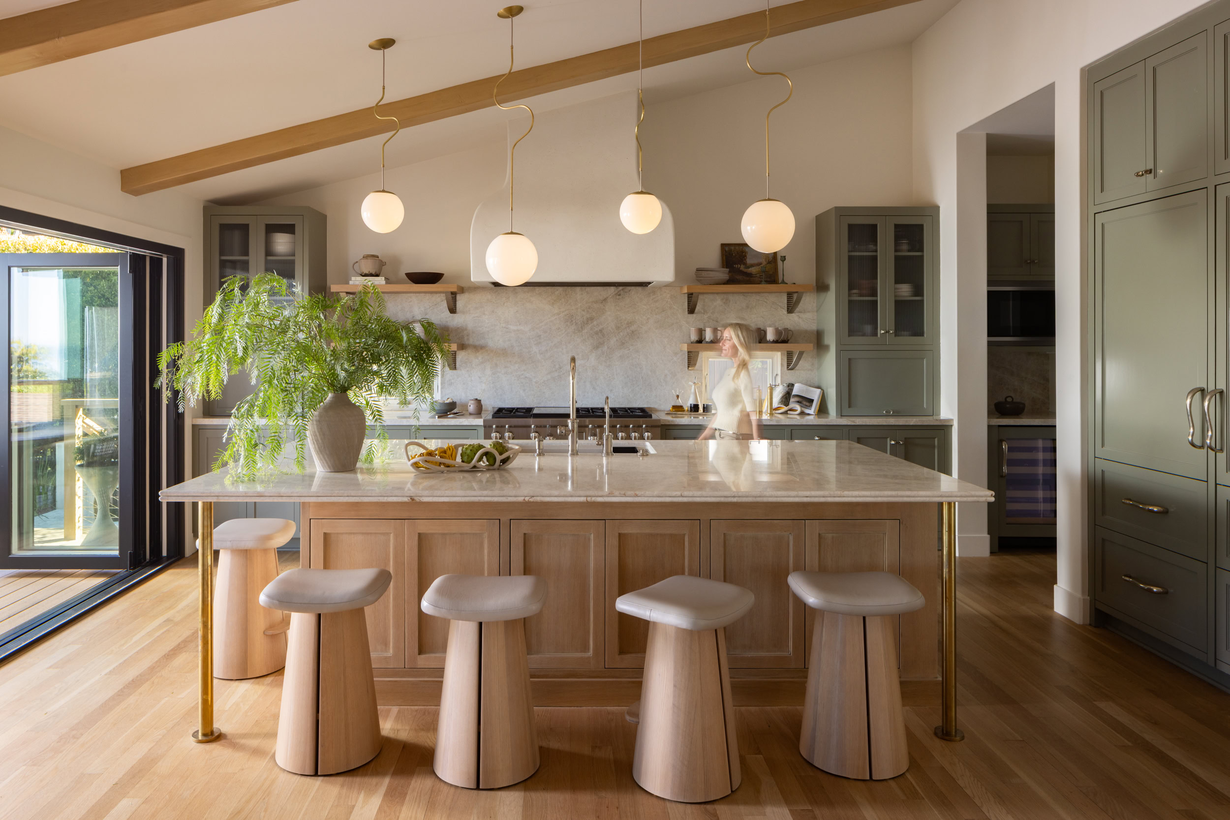 Contemporary kitchen featuring a large island, pendant lights, and stylish cabinetry for a sleek int.