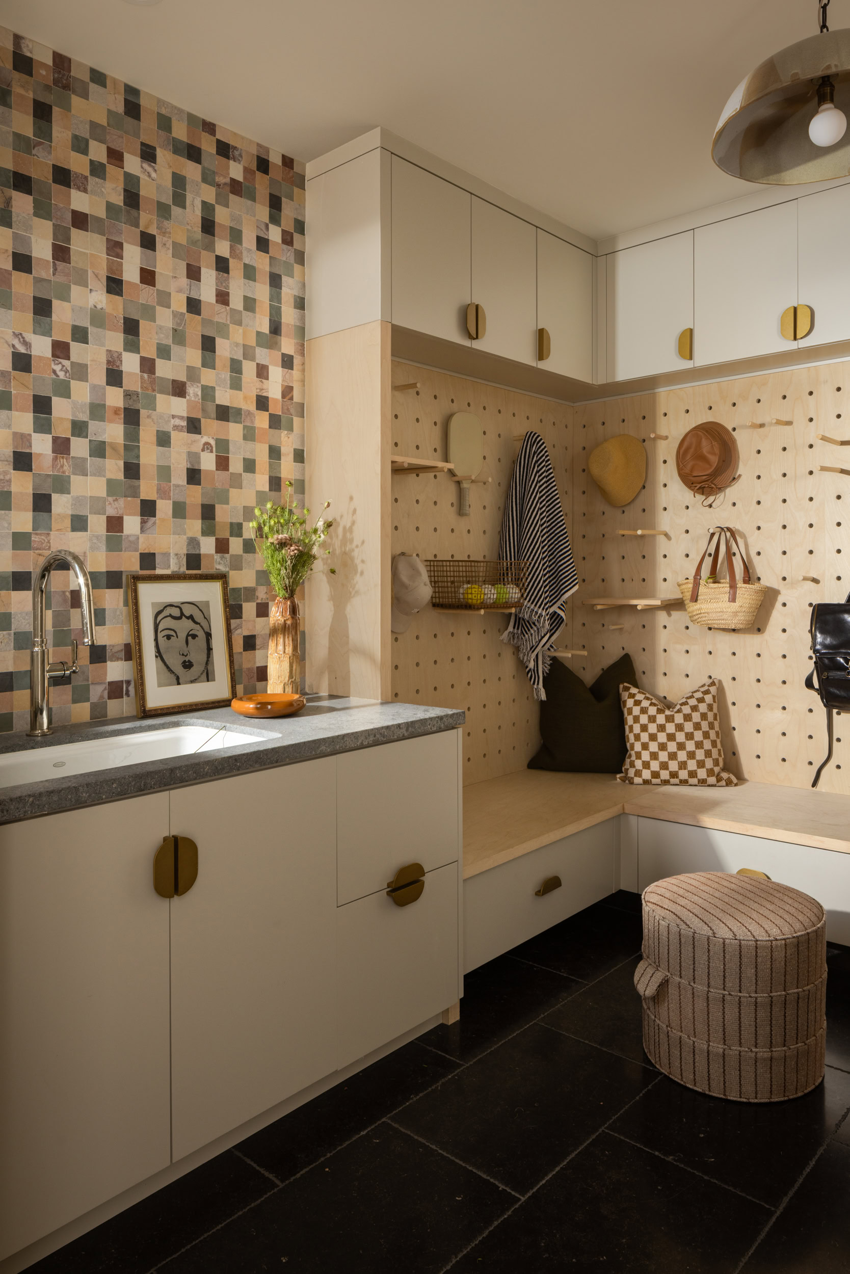 Stylish kitchen corner with storage, pegboard, and decorative accents.
