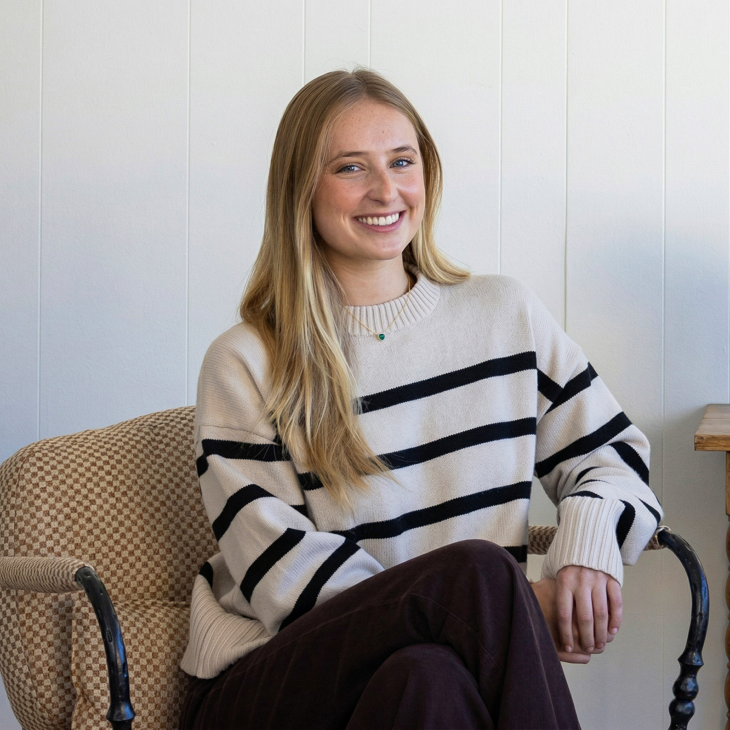 Portrait of Chloe Darché Maggs in a cozy interior setting at South Harlow Interiors.