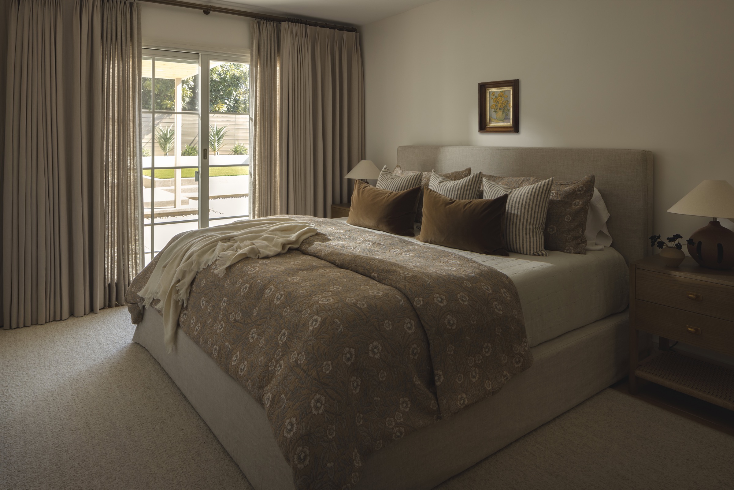 Cozy bedroom featuring neutral tones and plush bedding for relaxing interiors.