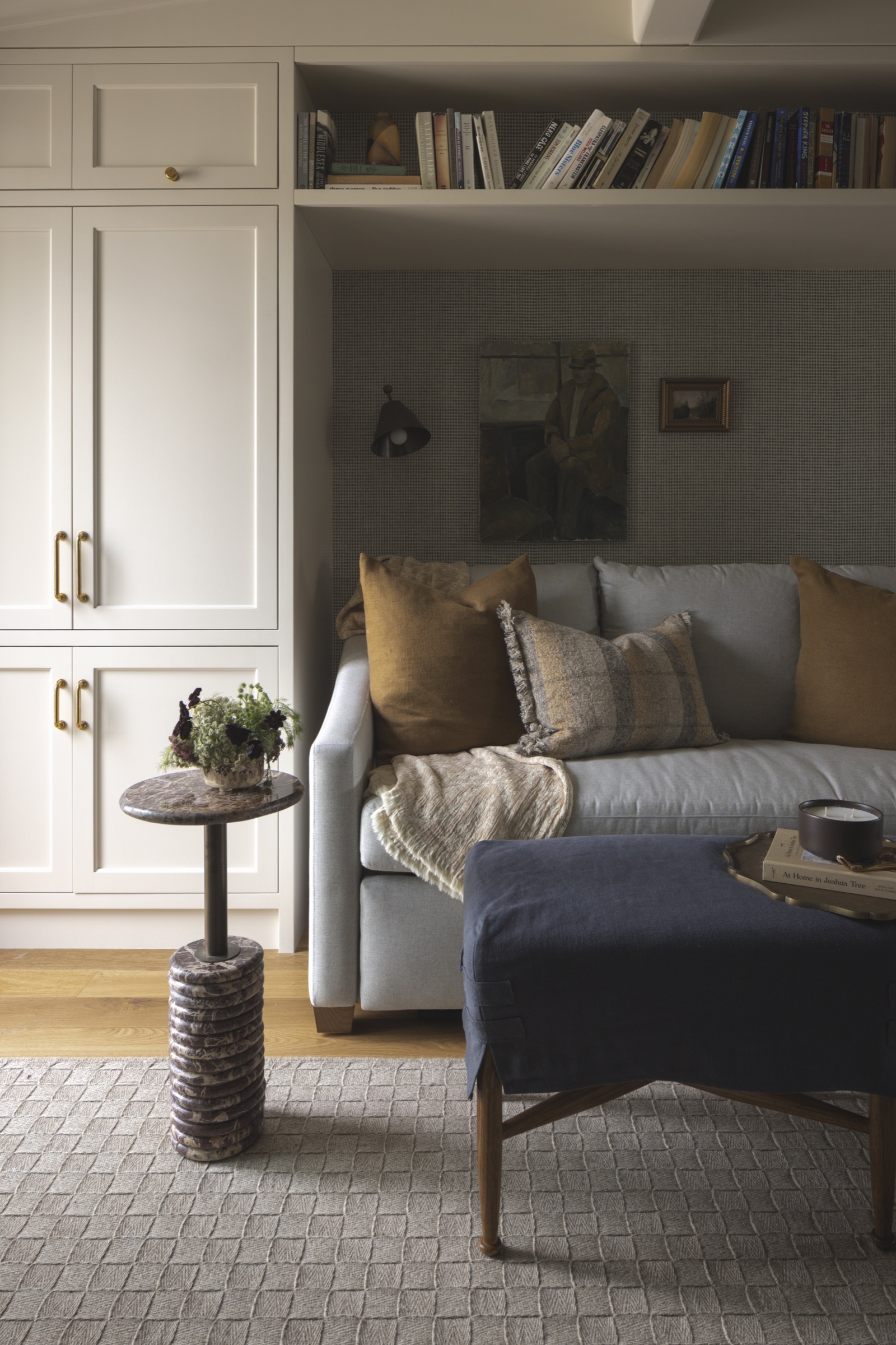 Stylish living room interior with sofa, bookshelves, and cozy accents.