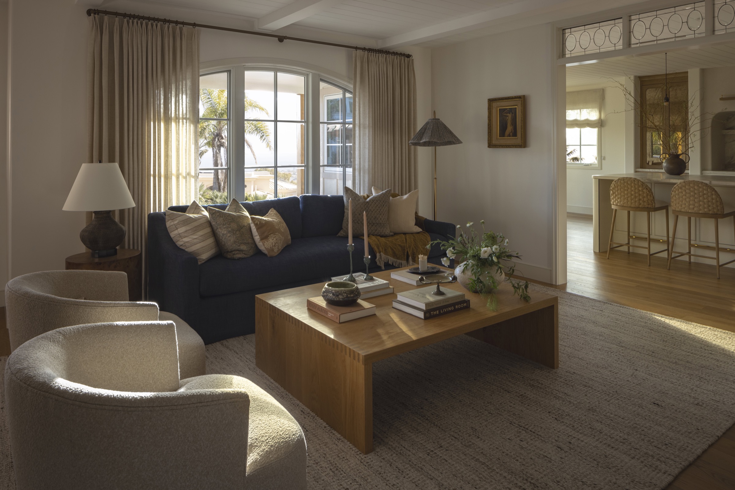 Bright living room with stylish furniture, large windows, and natural light.