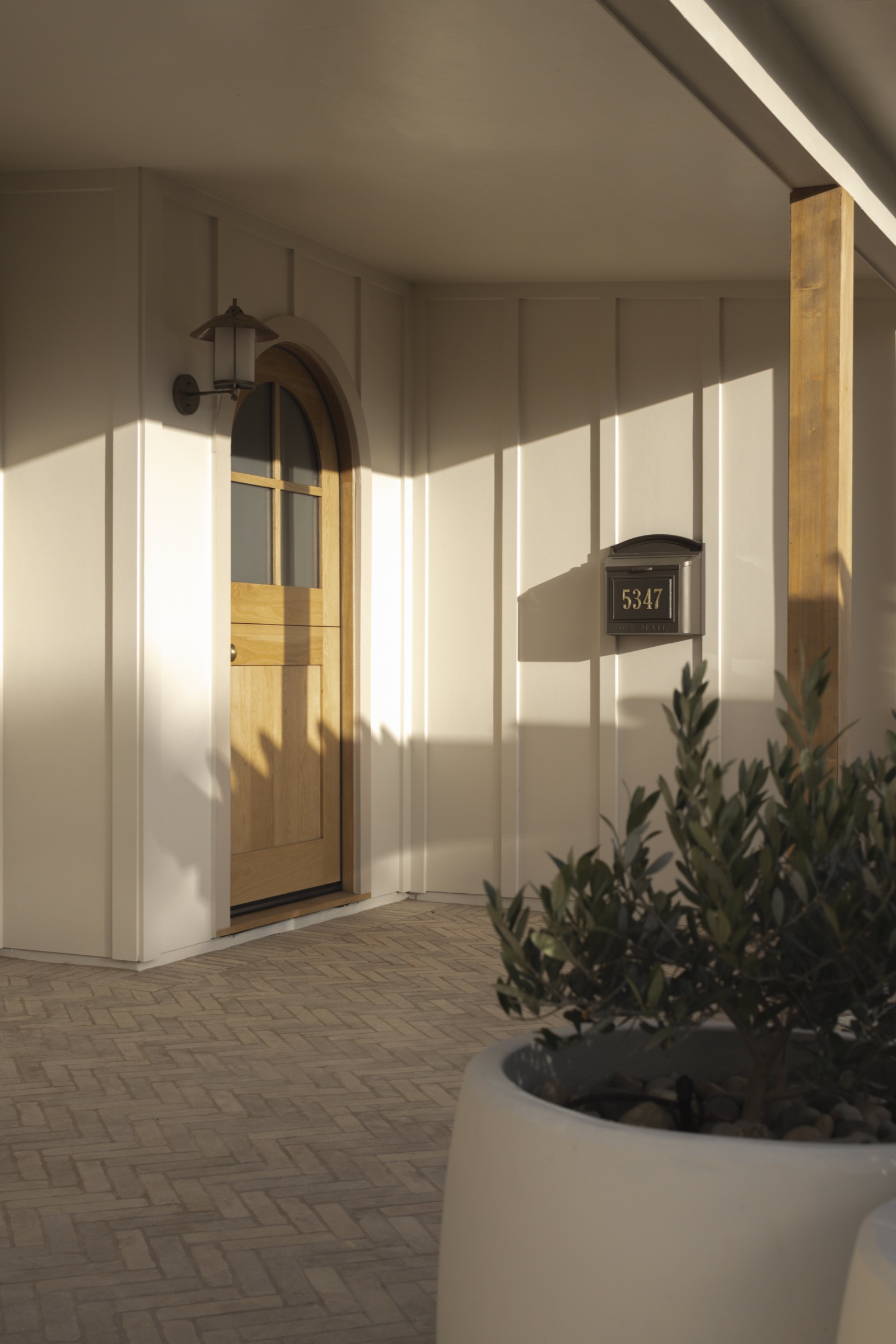 Entrance door with elegant wooden design and modern lighting.